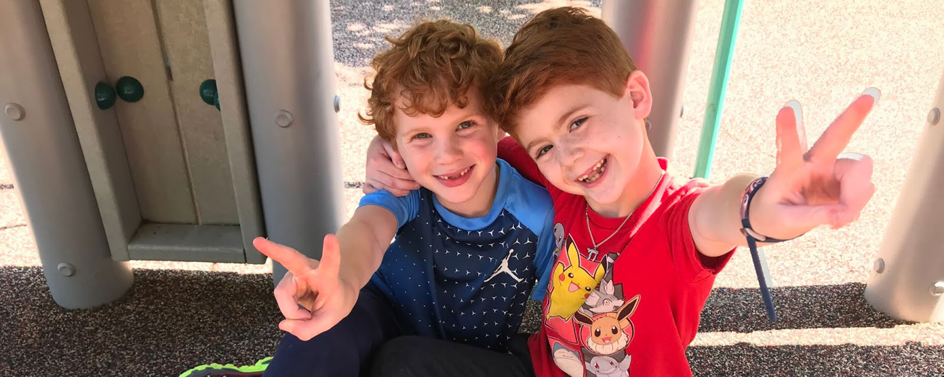 Two boys at recess showing a peace sign at The Rashi School, Reform Jewish K-8 Independent School