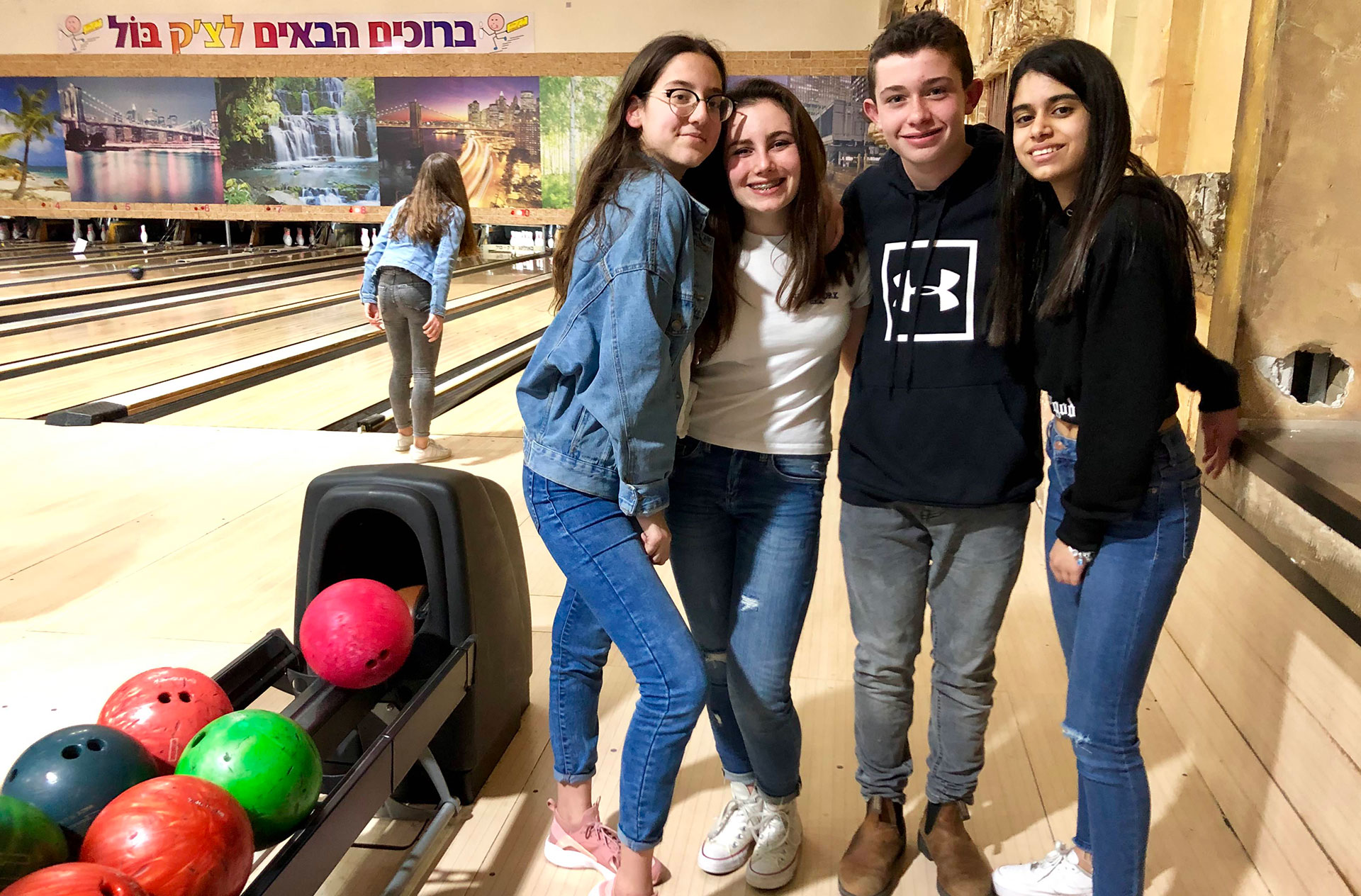 Israeli and American kids bowl together at an Israeli bowling alley.