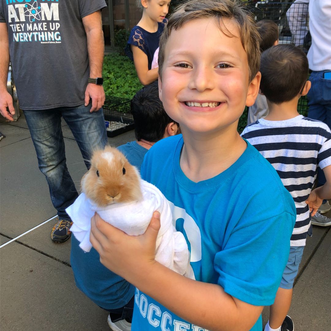 Farm visits Rashi student holding a baby rabbit