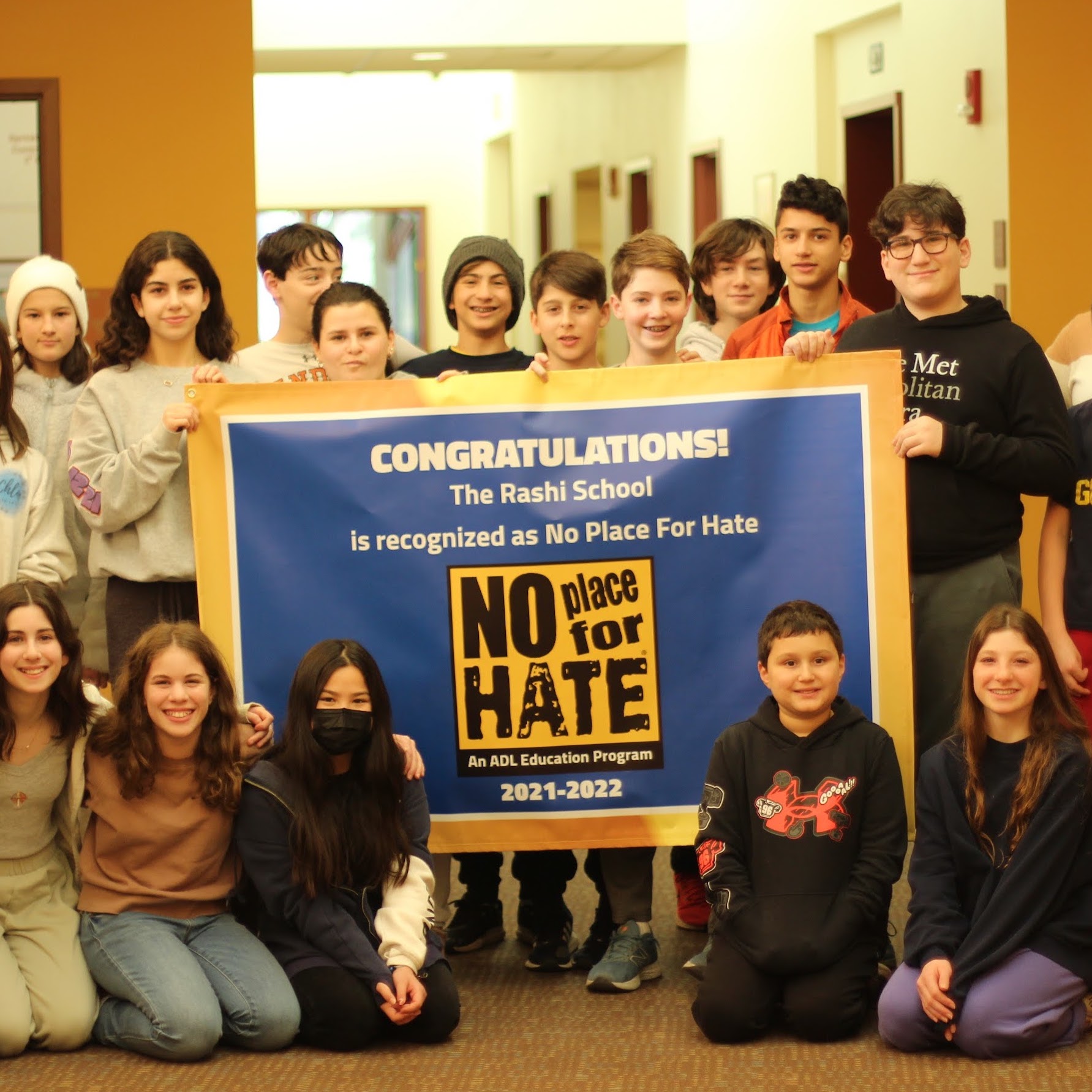 Students pose with their ADL-awarded "No Place for Hate" banner 