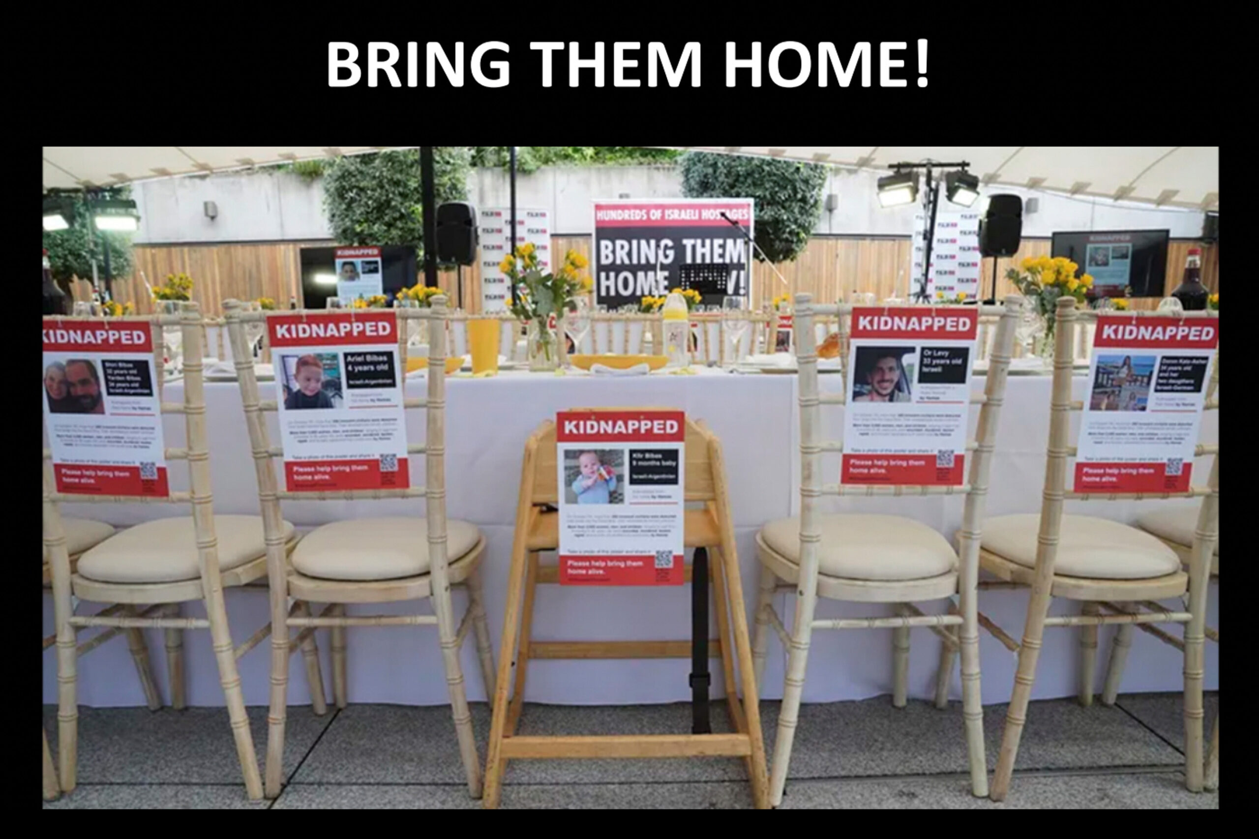 Images of Israeli hostages are placed around a mock-Shabbat table