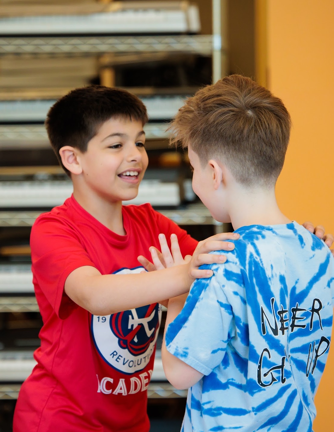 Two students smile while spending time on the playground